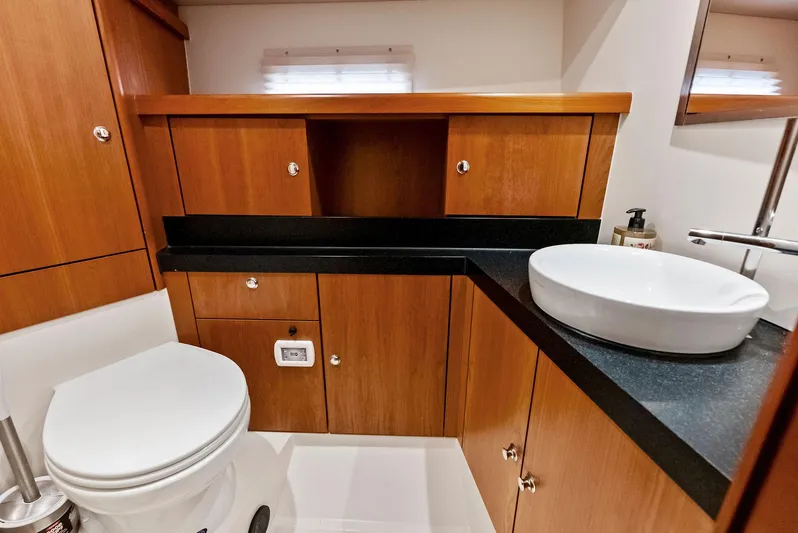 Southwind Yacht Photos Pics Modern bathroom in 2021 Moody 45 DS yacht with wooden cabinetry and white fixtures.
