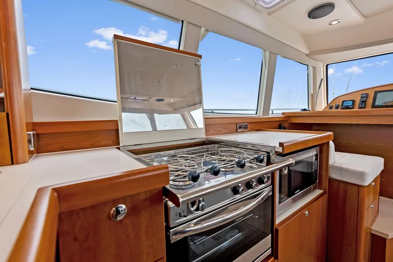 Southwind Yacht Photos Pics Modern kitchen area in a 2021 Moody 45 DS yacht with stove and oven.