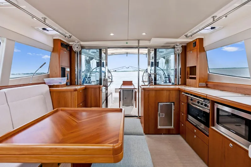 Southwind Yacht Photos Pics Luxurious interior of 2021 Moody 45 DS yacht with modern kitchen and dining area.