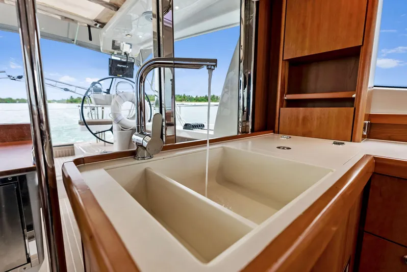 Southwind Yacht Photos Pics Modern kitchen sink on a 2021 Moody 45 DS yacht with water flowing.