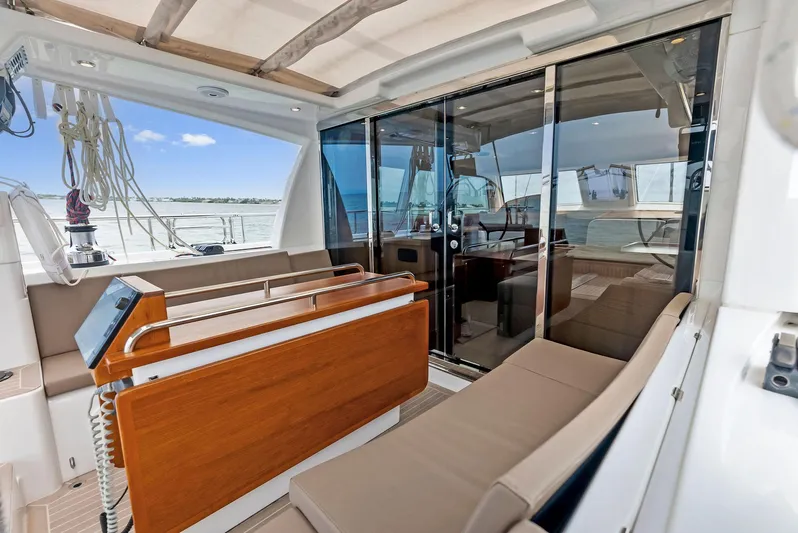 Southwind Yacht Photos Pics Modern interior of a 2021 Moody 45 DS yacht with comfortable seating and glass doors.