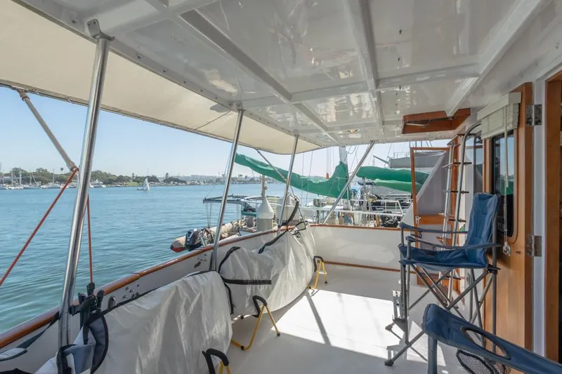 Betelgeuse Yacht Photos Pics 1988 DeFever 53 POC yacht deck with seating, overlooking marina.