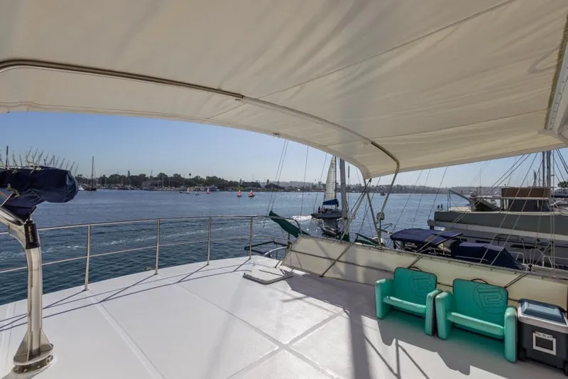 Betelgeuse Yacht Photos Pics 1988 DeFever 53 POC yacht deck with canopy and seating, overlooking marina.