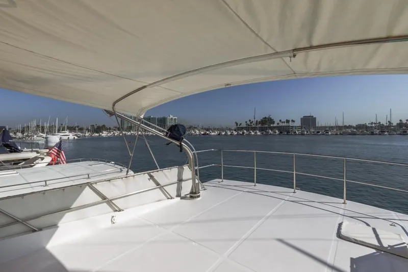 Betelgeuse Yacht Photos Pics 1988 DeFever 53 POC yacht deck with marina view, sunny day.