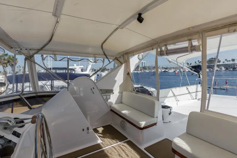 Betelgeuse Yacht Photos Pics 1988 DeFever 53 POC yacht interior with seating, overlooking marina.