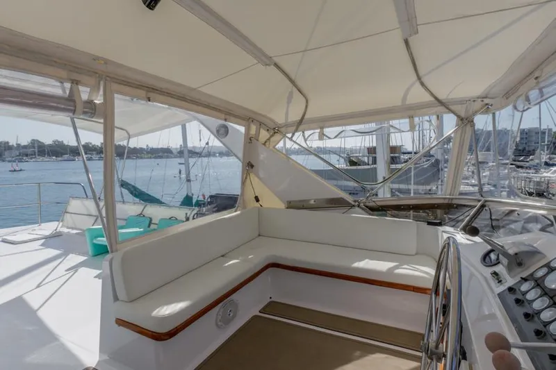 Betelgeuse Yacht Photos Pics 1988 DeFever 53 POC yacht cockpit with white seating and helm, docked at marina.