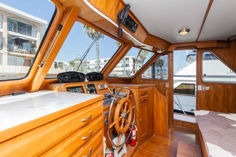 Betelgeuse Yacht Photos Pics 1988 DeFever 53 POC yacht interior with wooden helm and navigation equipment.
