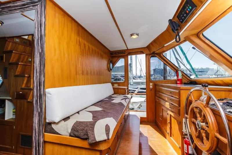 Betelgeuse Yacht Photos Pics Interior of 1988 DeFever 53 POC yacht with wooden finish and steering wheel.