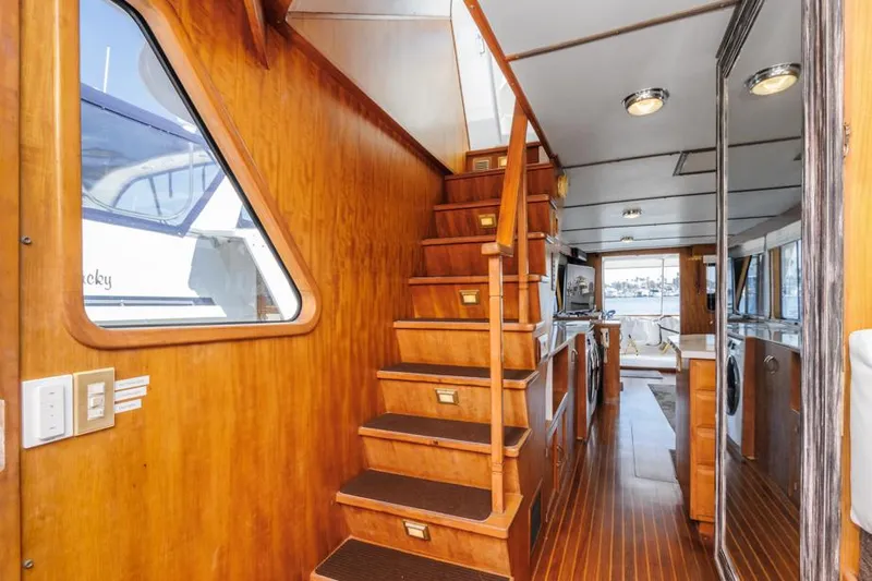Betelgeuse Yacht Photos Pics Interior of 1988 DeFever 53 POC yacht with wooden stairs and modern amenities.