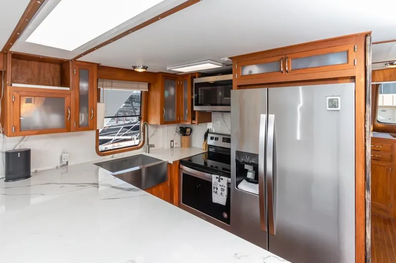 Betelgeuse Yacht Photos Pics Modern kitchen in 1988 DeFever 53 POC yacht with stainless steel appliances and wood cabinetry.