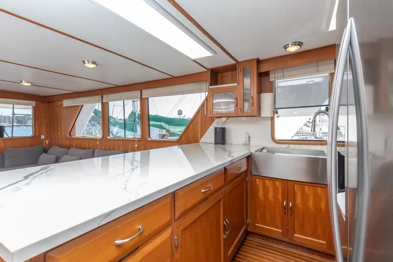 Betelgeuse Yacht Photos Pics Interior of 1988 DeFever 53 POC yacht with modern kitchen and large windows.