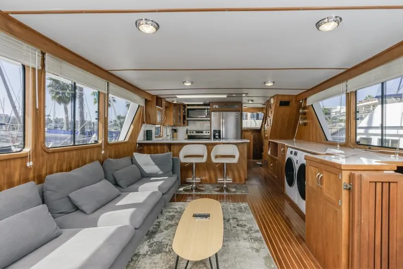 Betelgeuse Yacht Photos Pics Luxurious 1988 DeFever 53 POC yacht interior with modern kitchen and cozy seating area.