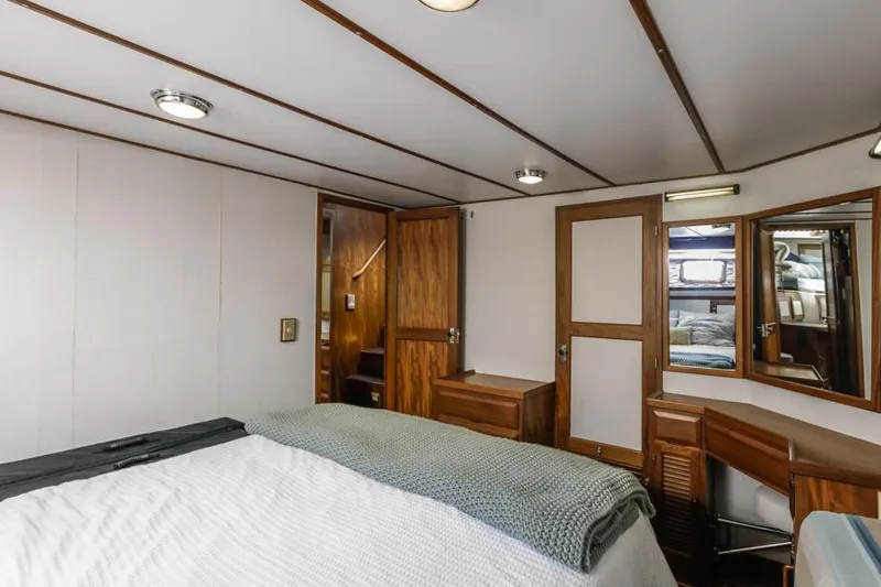 Betelgeuse Yacht Photos Pics 1988 DeFever 53 POC yacht bedroom with wood accents and cozy decor.