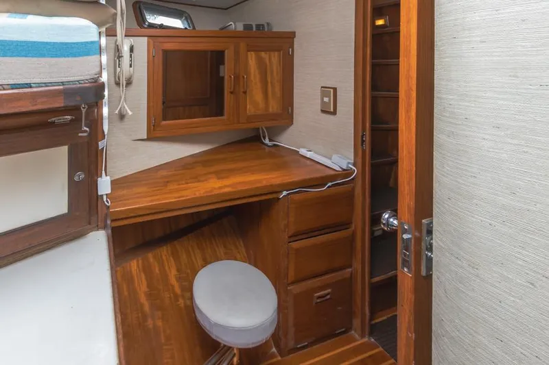 Betelgeuse Yacht Photos Pics 1988 DeFever 53 POC yacht interior with wooden desk and storage cabinets.