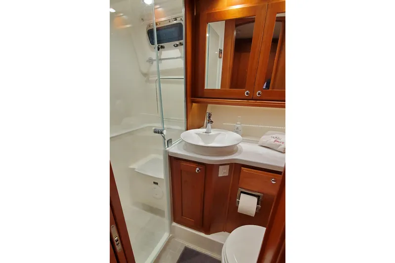 Ripple Yacht Photos Pics Luxurious bathroom in 2021 Sabre 45 Salon Express yacht with modern fixtures and wood cabinetry.