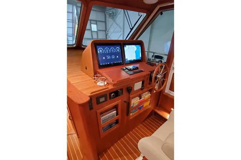 Ripple Yacht Photos Pics 2021 Sabre 45 Salon Express helm with navigation screens and wooden steering wheel.