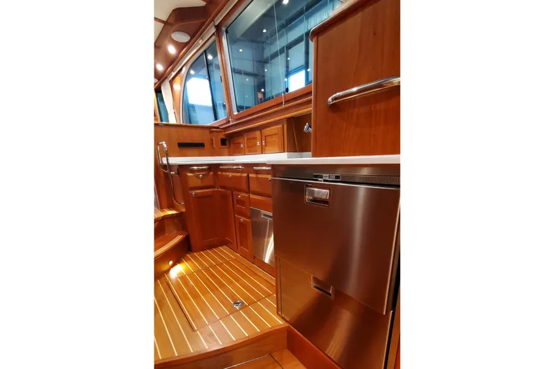 Ripple Yacht Photos Pics Interior of 2021 Sabre 45 Salon Express yacht with elegant wood cabinetry and stainless steel appliances.