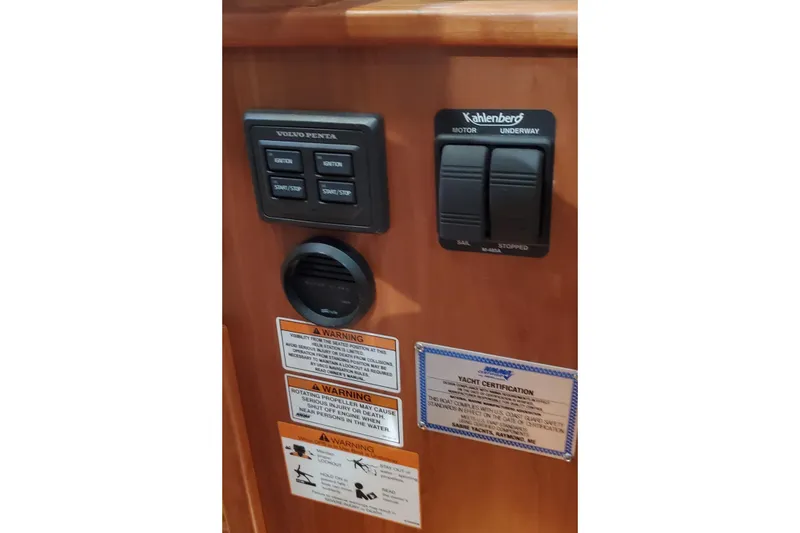 Ripple Yacht Photos Pics Control panel of 2021 Sabre 45 Salon Express with warning labels and yacht certification.