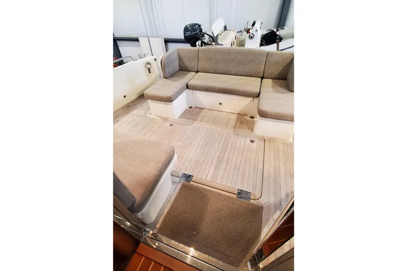 Ripple Yacht Photos Pics 2021 Sabre 45 Salon Express interior with beige seating and wooden flooring.