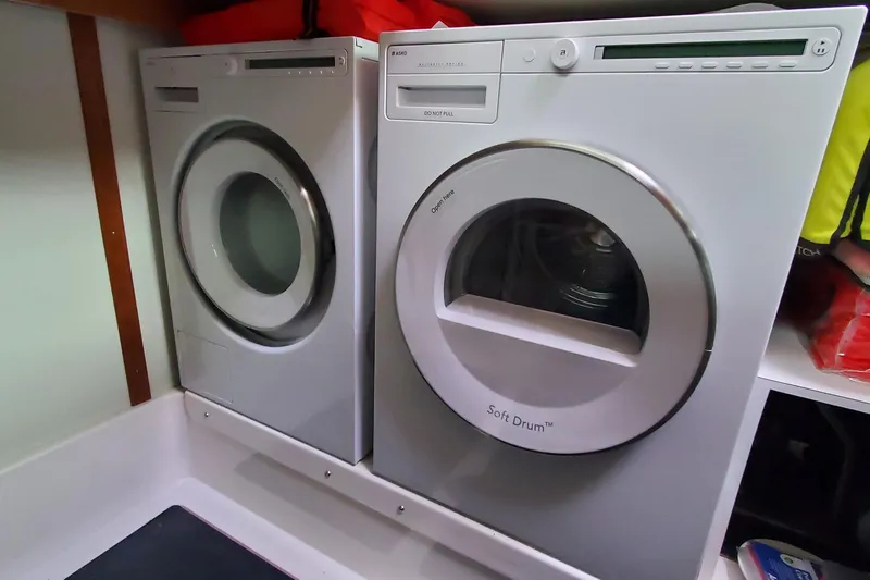 Ripple Yacht Photos Pics Laundry appliances inside 2021 Sabre 45 Salon Express yacht, featuring modern washer and dryer.