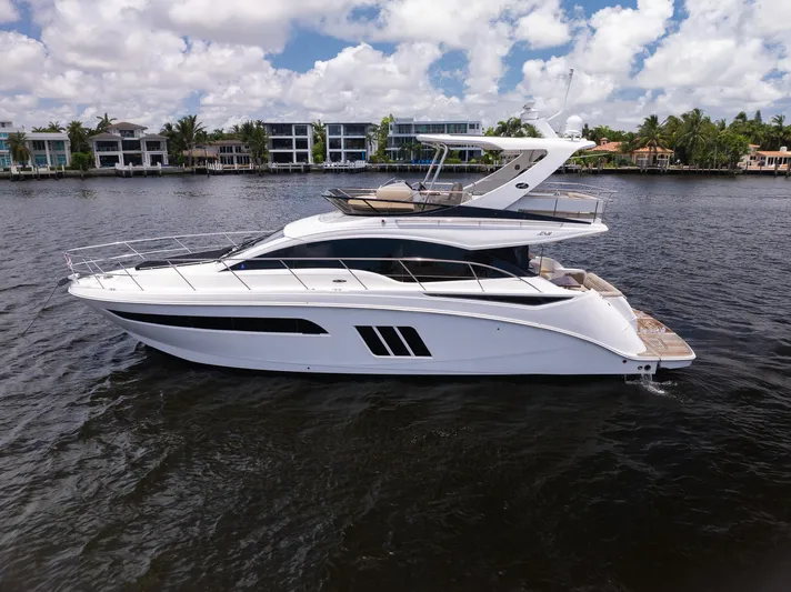 Get'er Done! Yacht Photos Pics 2016 Sea Ray 510 Fly yacht on water with modern homes in background.