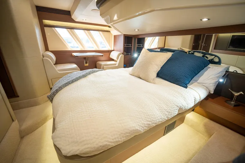 Get'er Done! Yacht Photos Pics Luxurious bedroom interior of 2016 Sea Ray 510 Fly yacht with cozy bed and seating area.