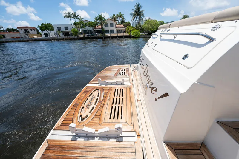 Get'er Done! Yacht Photos Pics 2016 Sea Ray 510 Fly yacht with wooden deck, docked by waterfront homes.