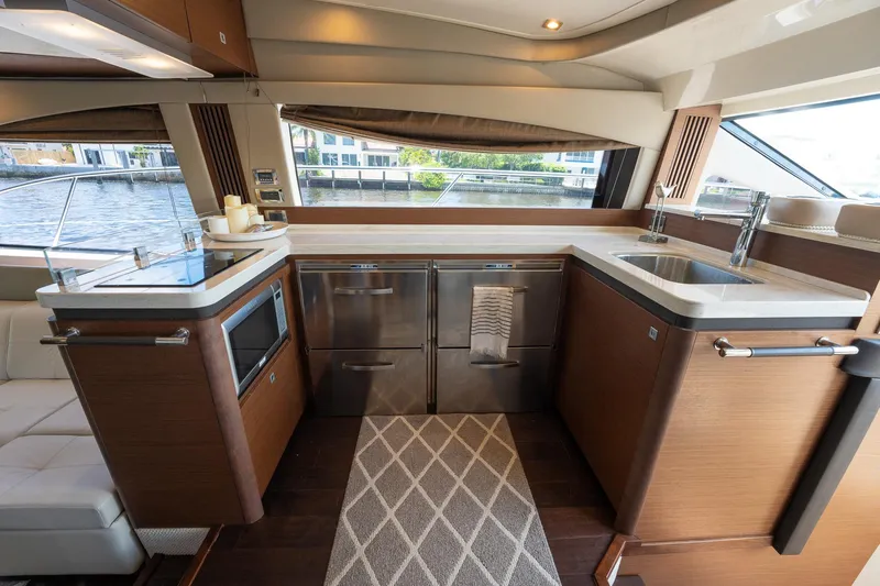 Get'er Done! Yacht Photos Pics Modern kitchen area in 2016 Sea Ray 510 Fly yacht with stainless steel appliances.