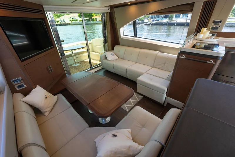 Get'er Done! Yacht Photos Pics Luxurious interior of 2016 Sea Ray 510 Fly yacht with modern seating and waterfront view.