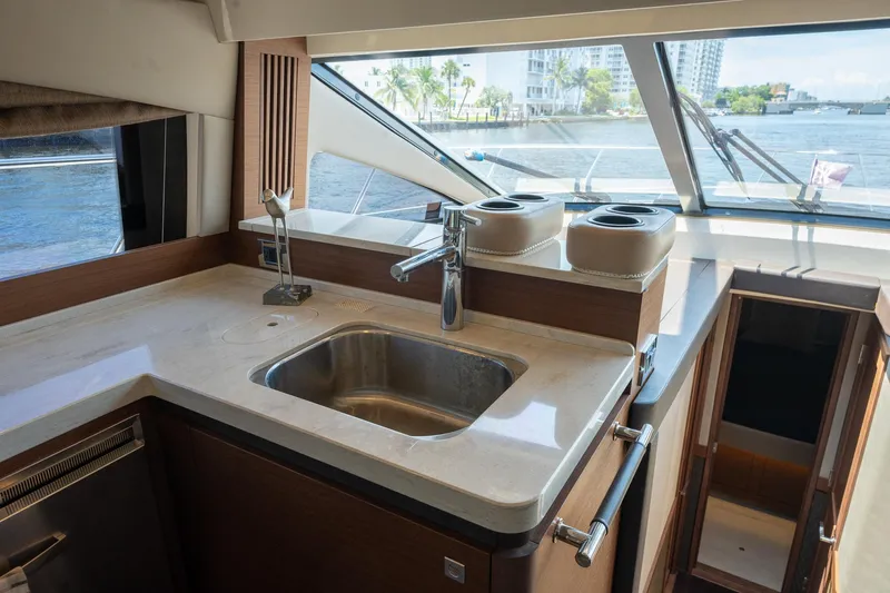 Get'er Done! Yacht Photos Pics 2016 Sea Ray 510 Fly yacht kitchen with sink and waterfront view.