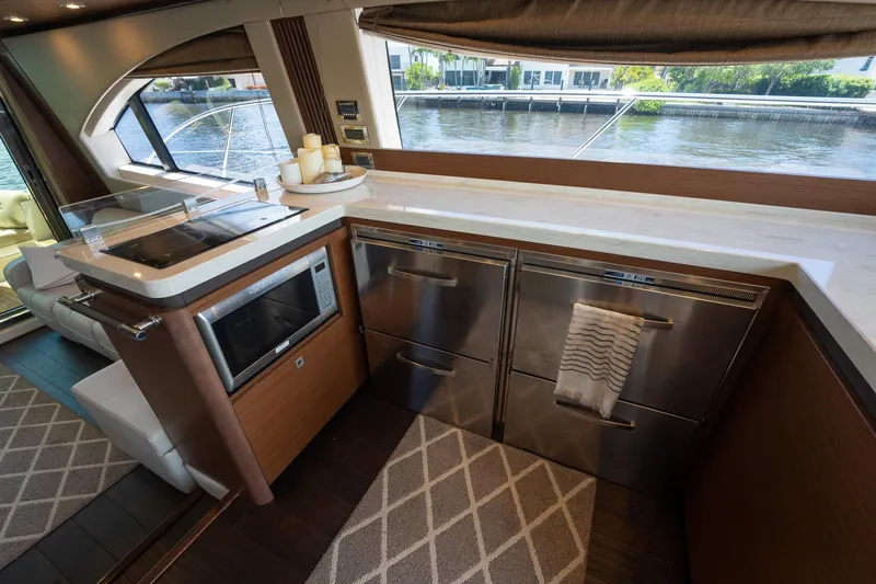Get'er Done! Yacht Photos Pics Modern kitchen area on a 2016 Sea Ray 510 Fly yacht with stainless steel appliances.