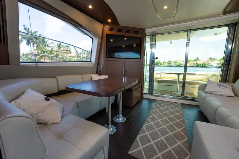 Get'er Done! Yacht Photos Pics Luxurious interior of 2016 Sea Ray 510 Fly yacht with modern seating and large windows.
