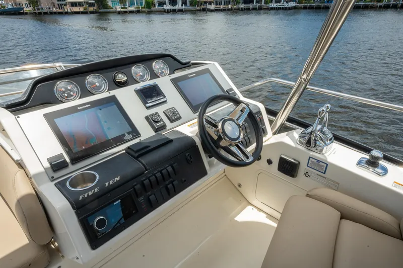 Get'er Done! Yacht Photos Pics 2016 Sea Ray 510 Flybridge helm station with dual displays and waterfront view.