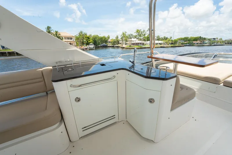 Get'er Done! Yacht Photos Pics Outdoor kitchen area on 2016 Sea Ray 510 Fly yacht with sink and seating.