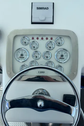 Sugar Bear Yacht Photos Pics Dashboard of a 2001 Cabo 45 Express boat with Simrad navigation system.