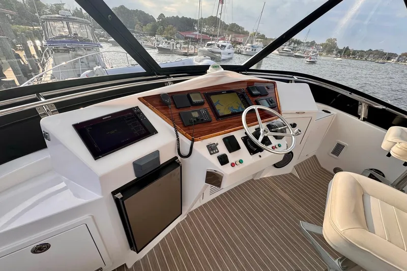 Necessity Yacht Photos Pics 2005 Albin 45 Command Bridge helm with navigation equipment and waterfront view.