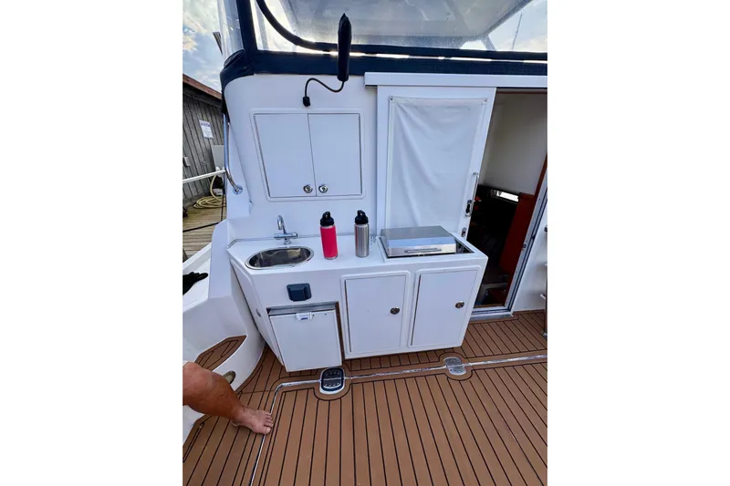 Necessity Yacht Photos Pics 2005 Albin 45 Command Bridge deck with sink, storage, and teak flooring.