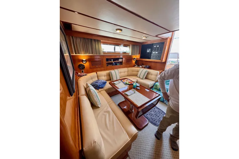 Necessity Yacht Photos Pics Luxurious interior of 2005 Albin 45 Command Bridge yacht with plush seating and wooden accents.