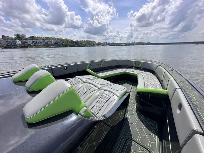  Yacht Photos Pics Luxurious 2022 Midnight Express 43' Solstice boat interior with green and gray seating on a sunny day.