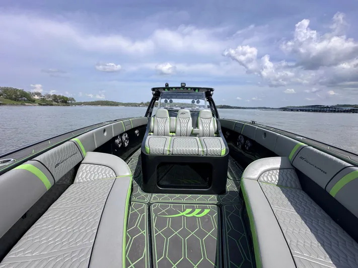  Yacht Photos Pics 2022 Midnight Express 43' Solstice boat interior with gray and green seating on a calm lake.