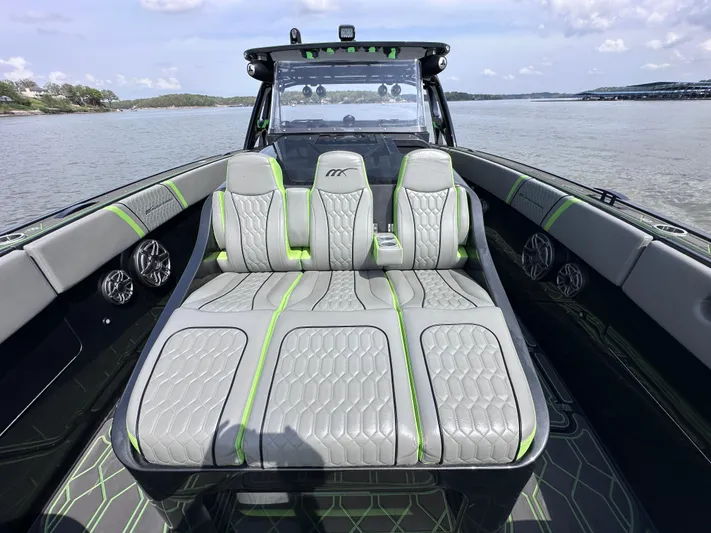  Yacht Photos Pics 2022 Midnight Express 43' Solstice boat with luxurious seating on a calm lake.