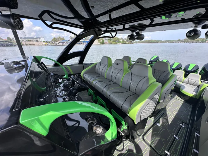  Yacht Photos Pics 2022 Midnight Express 43' Solstice boat interior with green and gray seating, docked by the water.