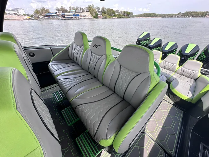  Yacht Photos Pics Luxurious seating on 2022 Midnight Express 43' Solstice boat, featuring green and gray upholstery.