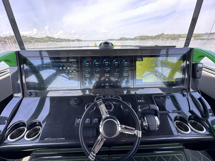  Yacht Photos Pics 2022 Midnight Express 43' Solstice dashboard with advanced navigation and control systems on a calm waterway.