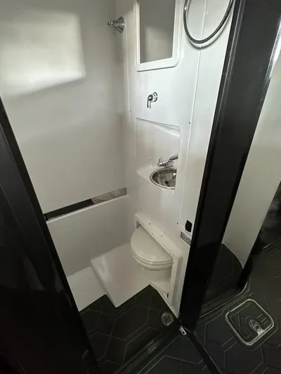  Yacht Photos Pics 2022 Midnight Express 43' Solstice boat bathroom with modern fixtures and compact design.