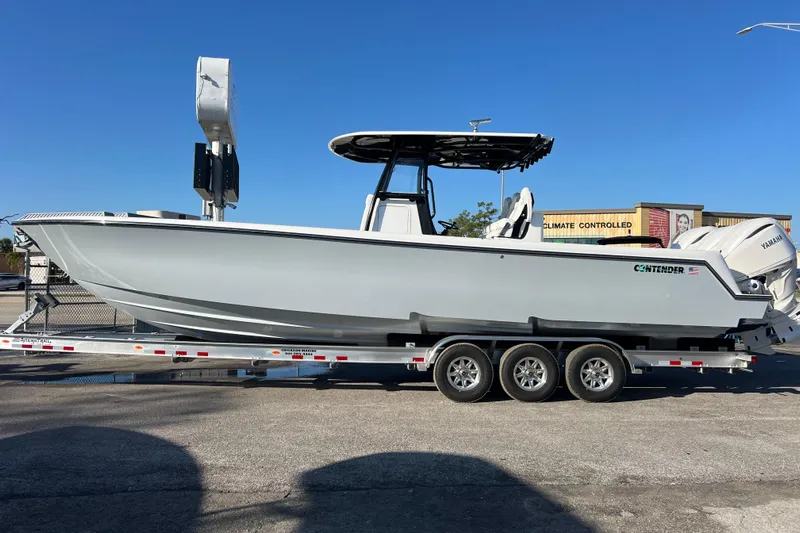  Yacht Photos Pics 2026 Contender 35 ST boat on trailer, featuring sleek design and triple-axle support.