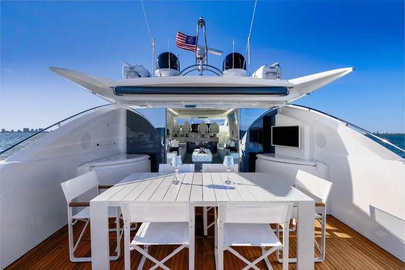 Skyfall Yacht Photos Pics 2008 Sunseeker Predator 108 yacht with elegant outdoor dining area and ocean view.