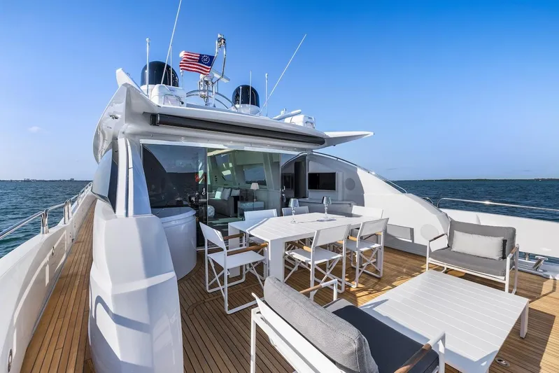 Skyfall Yacht Photos Pics Luxurious 2008 Sunseeker Predator 108 yacht deck with seating and dining area on open water.