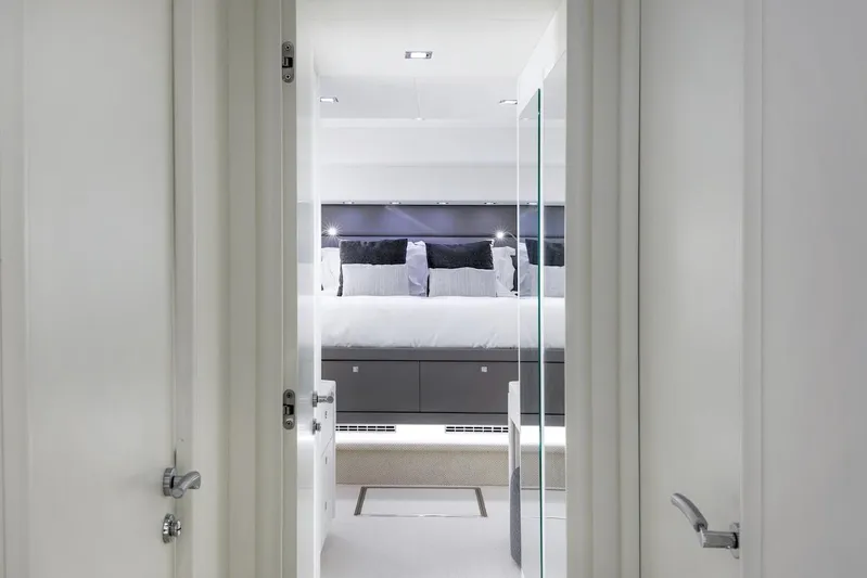 Skyfall Yacht Photos Pics Luxurious bedroom interior of 2008 Sunseeker Predator 108 yacht, featuring modern design and elegant decor.