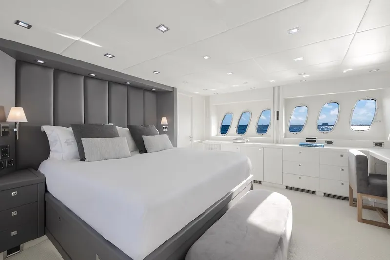 Skyfall Yacht Photos Pics Luxurious bedroom interior of 2008 Sunseeker Predator 108 yacht with ocean view windows.